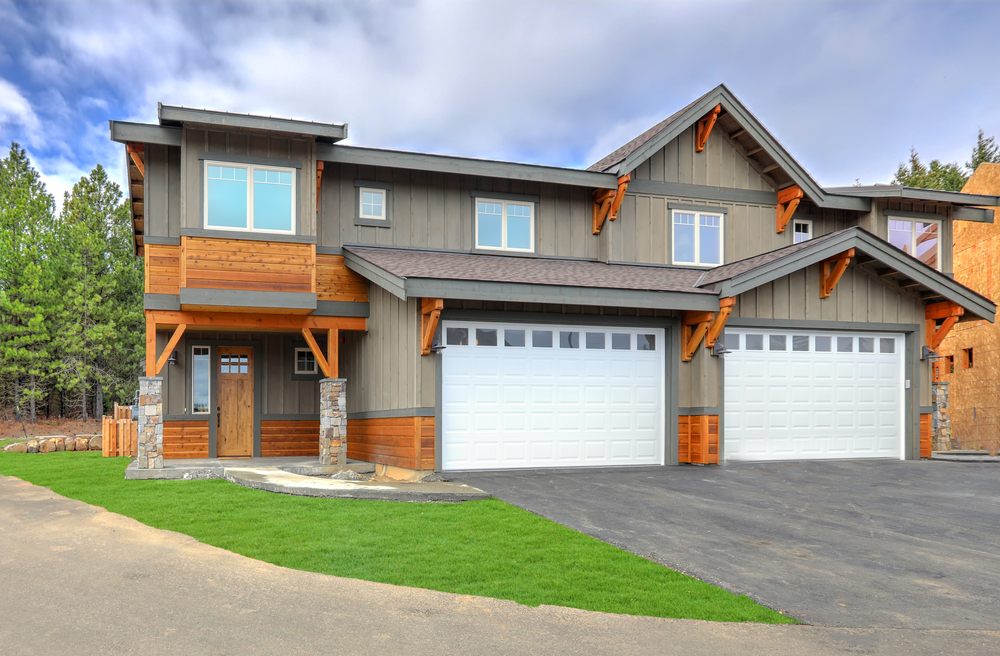 Home with two new white garage doors